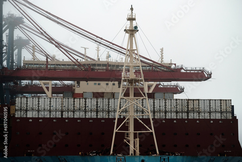 Large Container Vessel During Cargo Loading Operations In The Port
