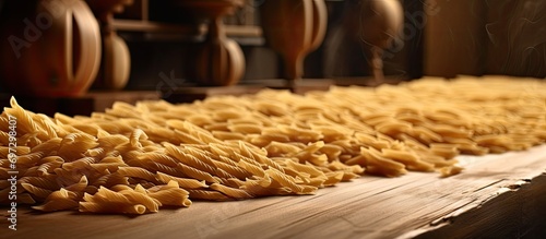 Raw pasta drying on wooden kitchen surface