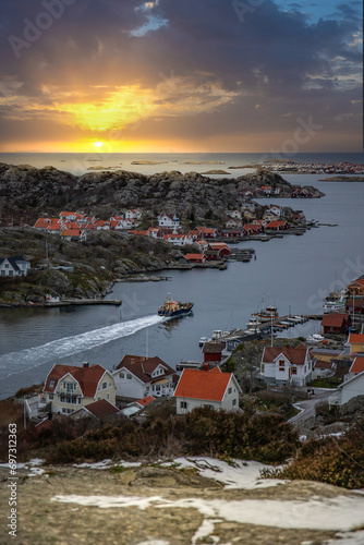 Beautiful typical Scandinavian village, winding around a coastal strip in a bay. Winter environment in a fishing village. Skyline of the town of Rönnäng in Sweden