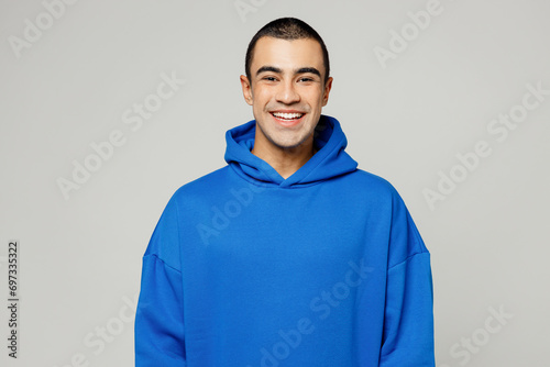 Young smiling cool fun happy cheerful satisfied positive middle eastern man he wear blue hoody casual clothes look camera isolated on plain solid white background studio portrait. Lifestyle concept.