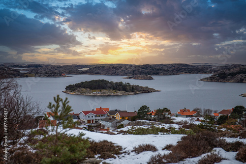 View over a stony coastal landscape in winter. Snow, ice and withered heather. Landscape shot in the town of Fjällbacka on the west coast of Sweden