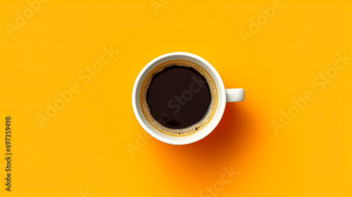 Top view of a white cup filled with aromatic coffee on a cheerful yellow background