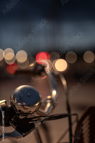 close-up of a bicycle saddle with blurred city light in the background