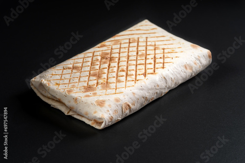 French tacos as a whole close up on a black background