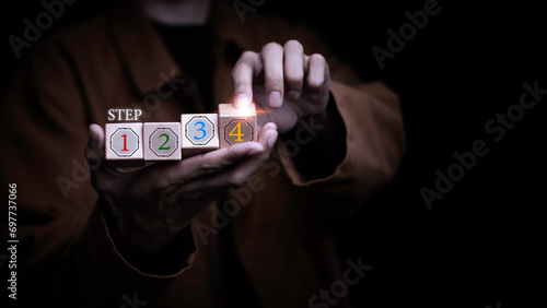 Businessman holds a hologram stacking as step by step. Ladder business growth personnel progress Following the steps correctly Traveling to a stable destination success in finance and investment.