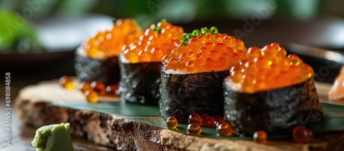 Fresh studio-lit Japanese sushi with salmon roe.