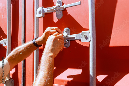 An inspector from Customs Department seals ready container for export