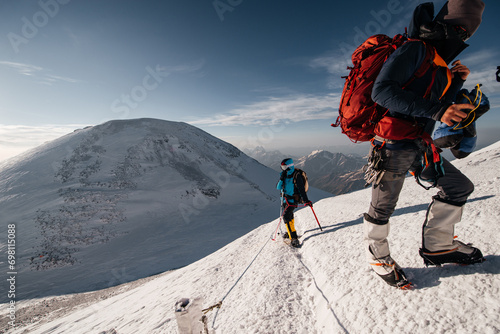 a girl climber walks along the snow-covered slope of Elbrus to the top