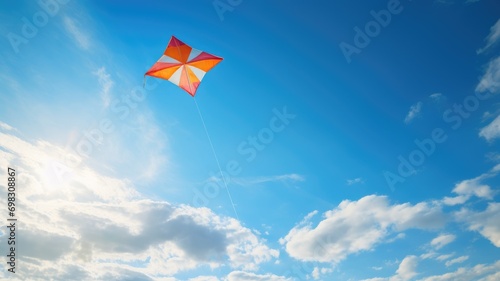 A colorful kite flying high in a bright blue sky