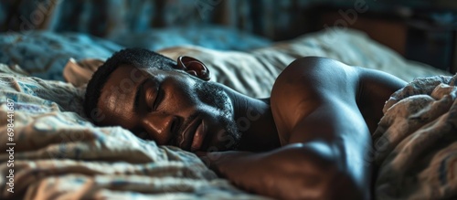 African American man peacefully sleeping in bed, relaxed and rested.