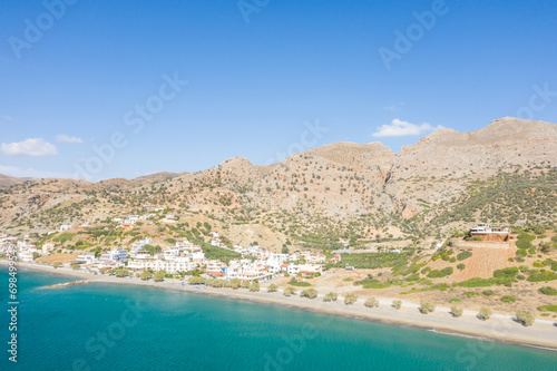 The city center at the foot of the arid mountains , in Europe, Greece, Crete, Tsoutsouros, By the Mediterranean Sea, in summer, on a sunny day.
