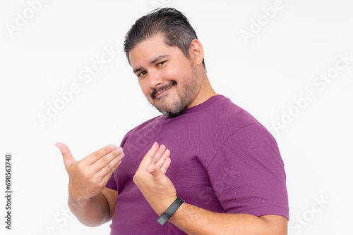 A cocky man points to himself bragging while looking smug. Wearing a purple waffle shirt. Half body photo isolated on white background.