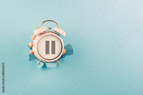 Alarm clock with pause sign, take a break, menopause concept, hormone replacement therapy