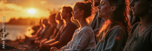 Group of people on a spiritual journey, engaged in a collective meditation session at sunset
