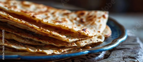 Layered flatbread, made with maida or whole wheat flour, commonly eaten during breakfast with spicy Asian curry gravy. Popular Indian dish.