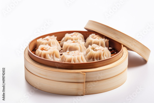 Bamboo steamer filled with Chinese Shumai dumplings on white background.For restaurant menus,culinary blogs and websites.