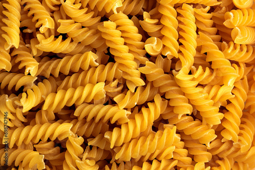 Overhead close-up view of uncooked fusilli pasta
