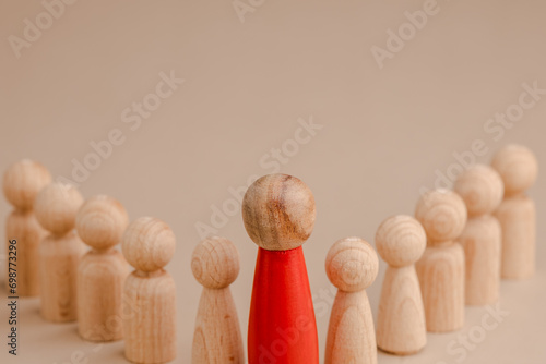 wooden figure representing a leader leading other figures. Leadership concept 