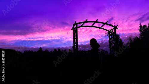 Silhouette of a woman on the background of a colorful sunset