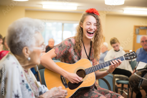 Volunteer Engages With Residents Through Reading Or Playing Music In Nursing Home