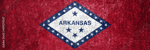Banner of the grunge Arkansas state flag. Dirty Arkansas state flag on a metal surface.