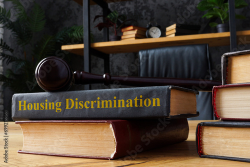Book with housing discrimination law and gavel.