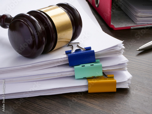 A stack of accounting papers and gavel. Financial white-collar crime and embezzlement.