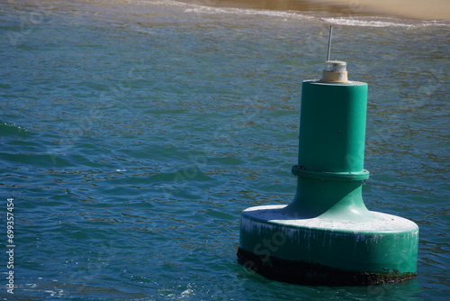 Green buoy floating in water