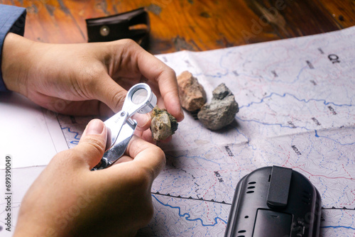 geologist using a loupe for rock and mineral identification and description