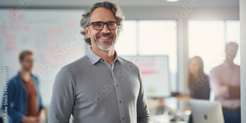 Portrait of creative caucasian happy man in casual wear talking and meeting with presentation Team discussing with colorful note paper on glass white office with sunrise lighting bokeh