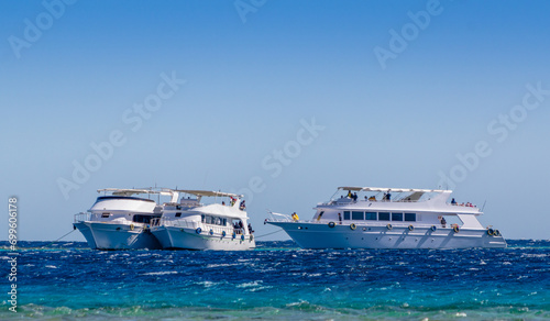 three white pleasure boat in the Red Sea in Egypt Dahab South Sinai
