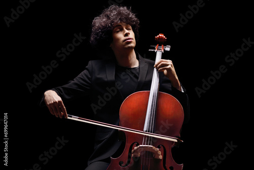 Young male artist playing a cello