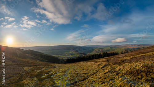 Aerial view overlooking moorland, woodland and a valley in the Yorkshire Dales. Taken at dusk in early winter.