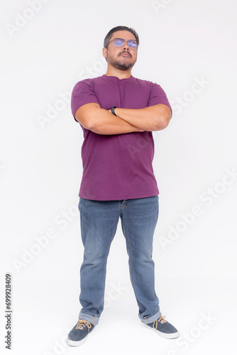 A chubby man wearing glasses trying to look tough, arms crossed . Full body photo, isolated on a white background.