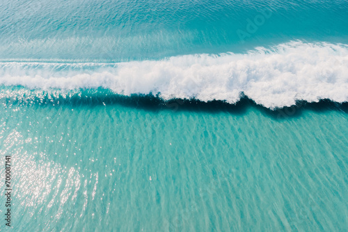 Blue ocean and surfing wave. Surfing waves in tropics. Aerial view