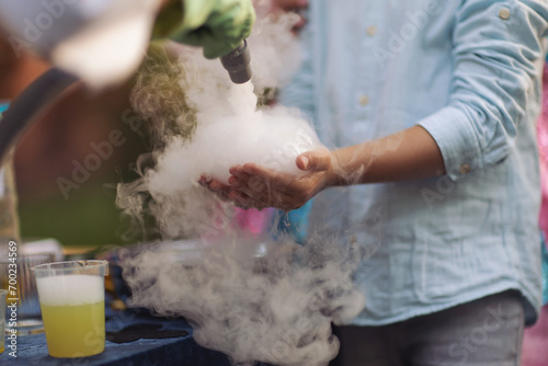 a bubble with steam in hands of a kid,science experiment. Nitrogen scientific experiments and show, shows for people and children. Chemical experiments. Foam and smoke after the experiments. Chemistry