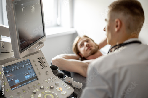 Ultrasound specialist examining lower abdomen of male patient. The concept of ultrasound diagnostics and men's health