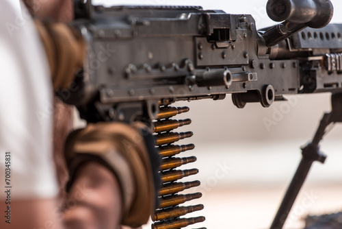Machine gun mounted on Humvee and person shooting the .50 Caliber. 
