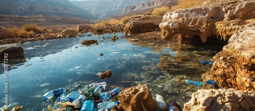 A polluted sinkhole near the Dead Sea, Israel, filled with plastic bottles and trash.
