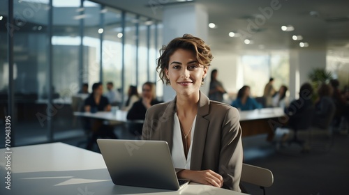 Smiling female office worker at desk portrait image copy space