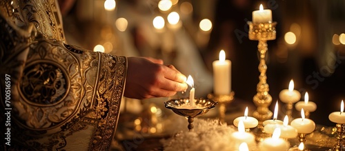 Christening ceremony in the Orthodox church priest lighting candles at children baptismal font close up. Creative Banner. Copyspace image