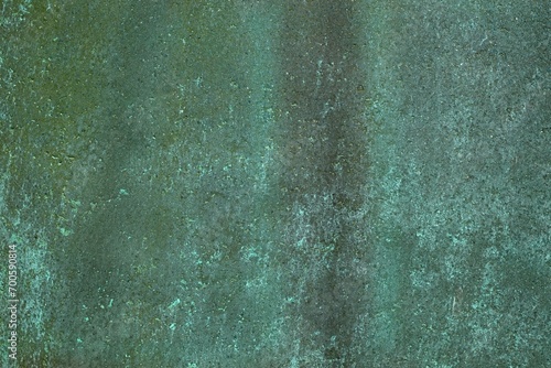 Closeup of aged weathered copper plate texture with green patina.