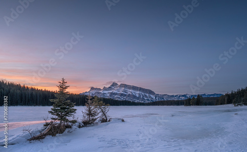 Winter view of spruce trees and Mount Rundle at Two Jack Lake in Banff National Park, Alberta, Canada
