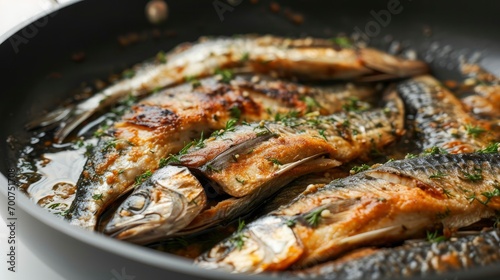 Close up of sardine meat in a pan isolated on a clear white background.
