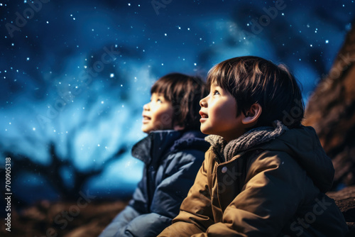 Stargazing Wonder: Two Children Embracing the Night Sky 
