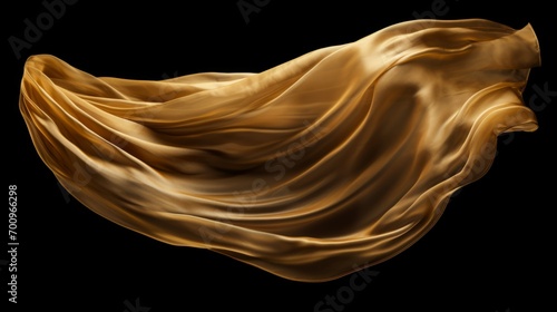 Gold cloth that is floating and hiding something unknown underneath. Fabric isolated on black background. 