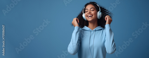 African American teenager young woman with headphone listen to music with happiness, World hearing day.