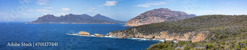 Panorama looking south over the Tasman Sea to Wineglass Bay and Carp Bay. To the right are The Hazard mountains with Mt Freycinet, Mt Graham, Cape Forestier and Lemon Rock to the far left.
