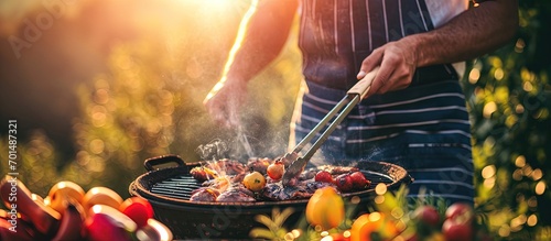 Man cooking tasty food on barbecue grill outdoors closeup. Creative Banner. Copyspace image