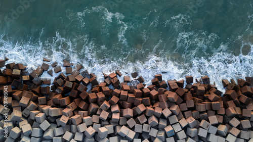 Breakwater seen from the drone. Waves breaking on the rocks of the pier. Concrete blocks in the sea. aerial photography. Ocean.